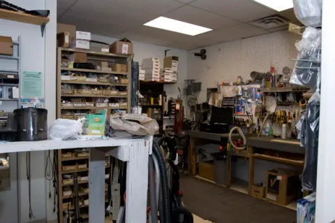 Parts shelves and the repair workbench inside the CFI Vacuum workshop in Richmond, Virginia